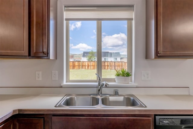 850 Pollux Rd, Helena, MT 59602 - kitchen featuring a sink, dishwasher, light countertops, and dark brown cabinets