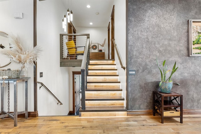 4884 Lower Miller Creek Rd, Missoula, MT 59803 - staircase with wood finished floors, recessed lighting, and a high ceiling