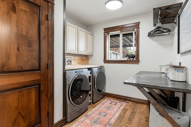 4884 Lower Miller Creek Rd, Missoula, MT 59803 - laundry area with cabinet space, independent washer and dryer, and light wood-style flooring