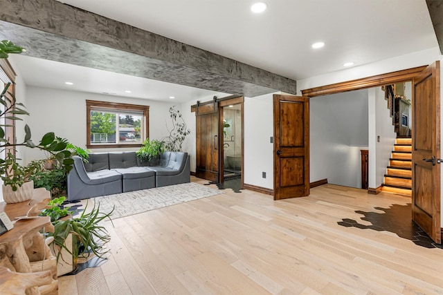 4884 Lower Miller Creek Rd, Missoula, MT 59803 - living room with a barn door, light wood-style flooring, stairs, and recessed lighting