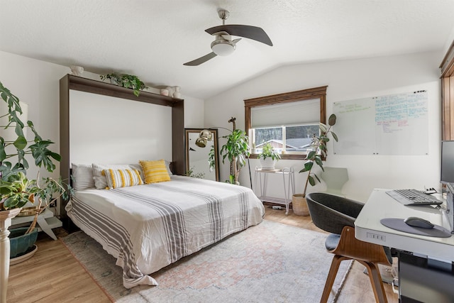 4884 Lower Miller Creek Rd, Missoula, MT 59803 - bedroom featuring light wood-style flooring, vaulted ceiling, a desk, and a ceiling fan
