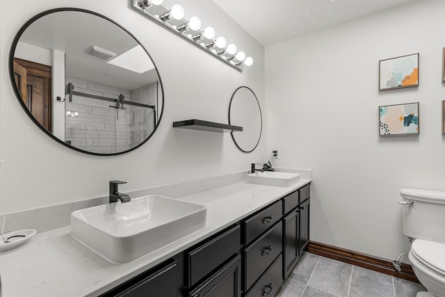 4884 Lower Miller Creek Rd, Missoula, MT 59803 - bathroom with double vanity, a tile shower, and a textured ceiling