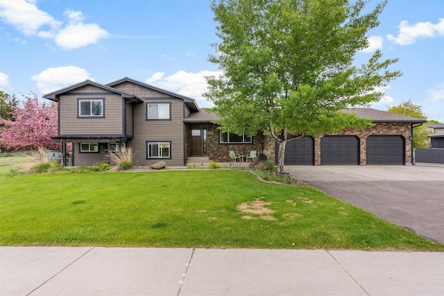4884 Lower Miller Creek Rd, Missoula, MT 59803 - tri-level home with asphalt driveway, a front lawn, and a garage