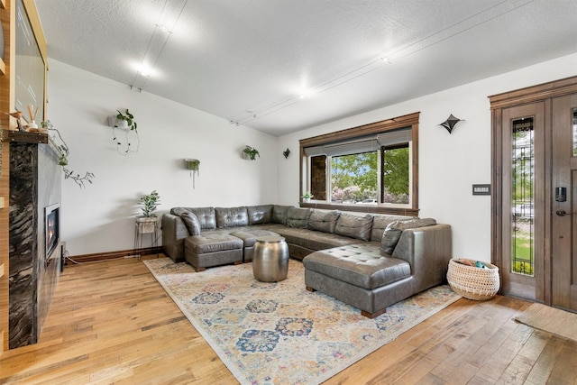 4884 Lower Miller Creek Rd, Missoula, MT 59803 - living room with light wood finished floors and a lit fireplace