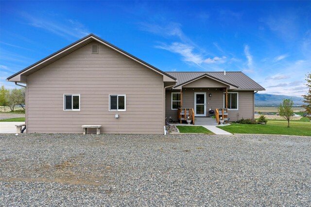 33 Windy Meadow Dr, Townsend, MT 59644 - rear view of house featuring metal roof and a yard