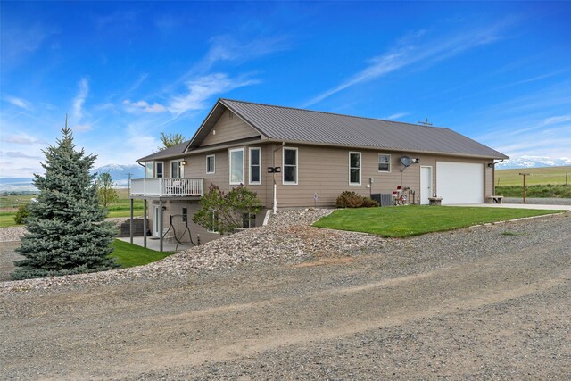 33 Windy Meadow Dr, Townsend, MT 59644 - view of front of property with an attached garage, driveway, central air condition unit, metal roof, and a front yard