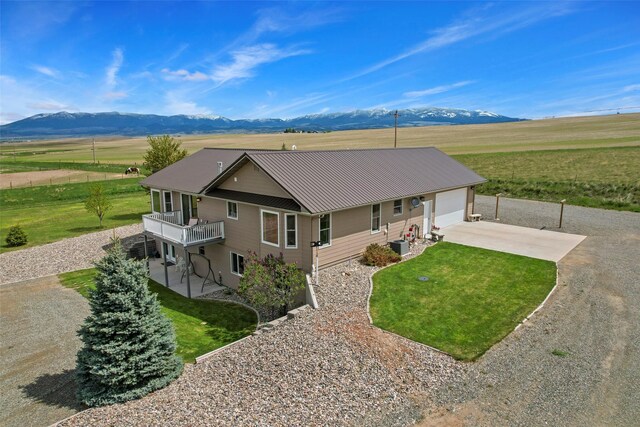 33 Windy Meadow Dr, Townsend, MT 59644 - view of front of house with concrete driveway, a mountain view, a front lawn, and a view of rural / pastoral area