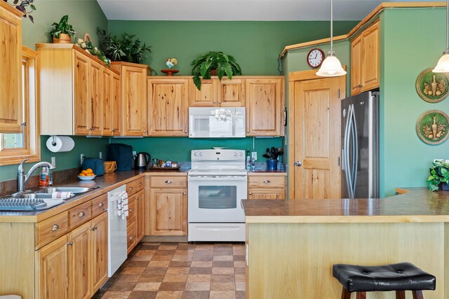 33 Windy Meadow Dr, Townsend, MT 59644 - kitchen featuring white appliances, a sink, light brown cabinets, a kitchen bar, and decorative light fixtures