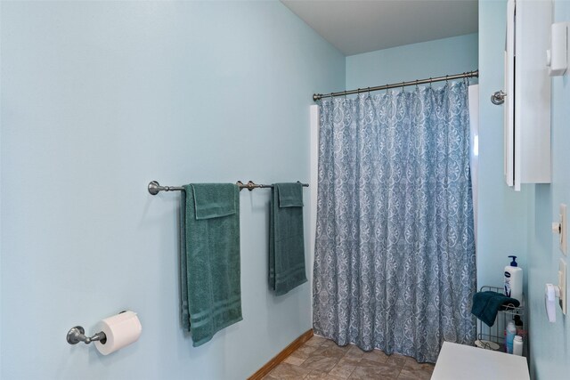 33 Windy Meadow Dr, Townsend, MT 59644 - bathroom with a shower with shower curtain and baseboards