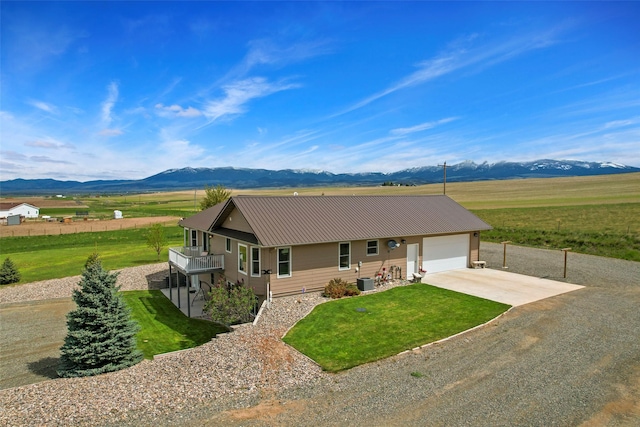 33 Windy Meadow Dr, Townsend, MT 59644 - single story home with a mountain view, concrete driveway, a garage, metal roof, and central air condition unit