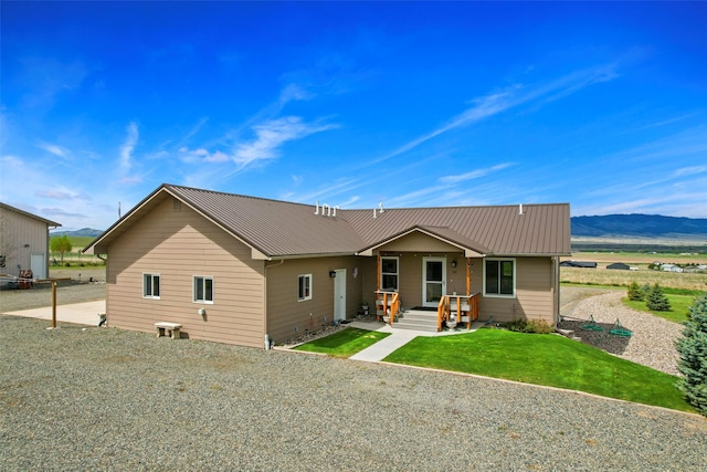 33 Windy Meadow Dr, Townsend, MT 59644 - back of house featuring metal roof, a mountain view, and a lawn
