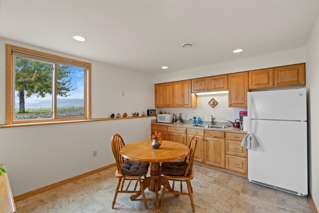 33 Windy Meadow Dr, Townsend, MT 59644 - kitchen featuring white appliances, a sink, light countertops, recessed lighting, and baseboards