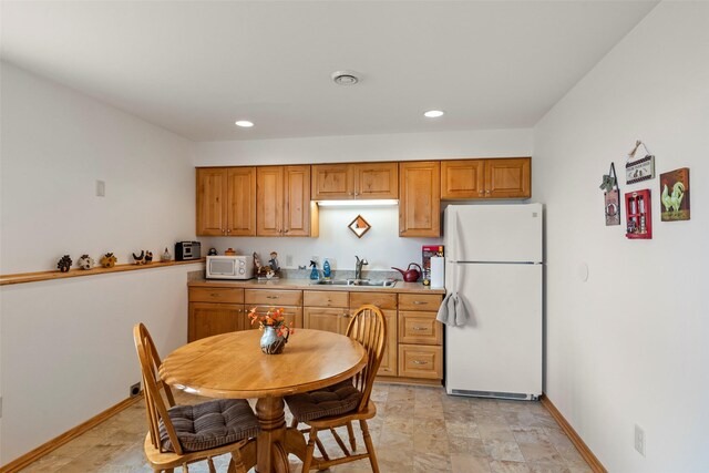 33 Windy Meadow Dr, Townsend, MT 59644 - kitchen featuring white appliances, a sink, recessed lighting, baseboards, and light countertops