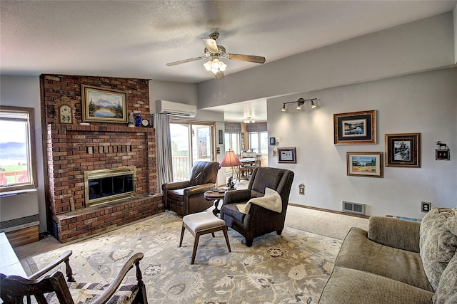 31521 Mcdonald Lake Rd, Saint Ignatius, MT 59865 - living room featuring a wall mounted AC, a ceiling fan, a brick fireplace, carpet floors, and a textured ceiling
