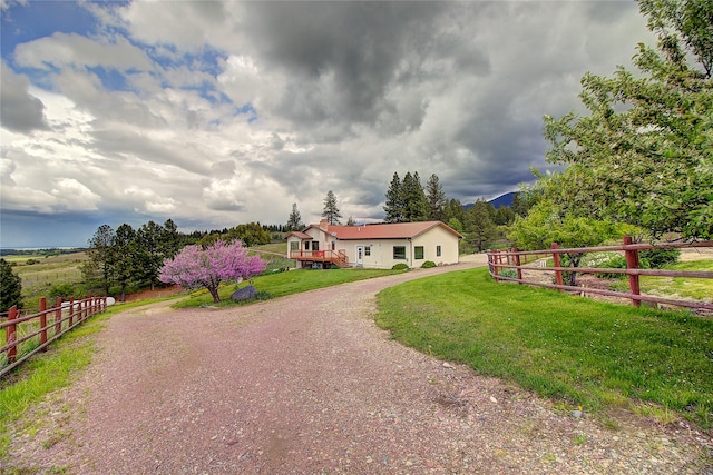 31521 Mcdonald Lake Rd, Saint Ignatius, MT 59865 - single story home featuring curved driveway, a deck, and a view of rural / pastoral area