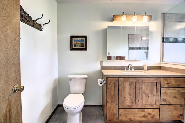 31521 Mcdonald Lake Rd, Saint Ignatius, MT 59865 - bathroom featuring tile patterned flooring, toilet, vanity, and baseboards