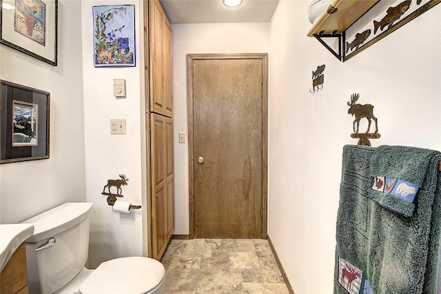 31521 Mcdonald Lake Rd, Saint Ignatius, MT 59865 - entryway with stone finish flooring, baseboards, and a textured ceiling