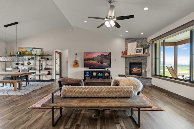 219 Rudys Way, Hamilton, MT 59840 - living area with lofted ceiling, a stone fireplace, a ceiling fan, wood finished floors, and baseboards