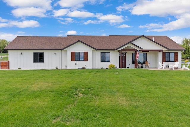 219 Rudys Way, Hamilton, MT 59840 - view of front of house featuring a patio area, a front yard, roof with shingles, and an outdoor hangout area