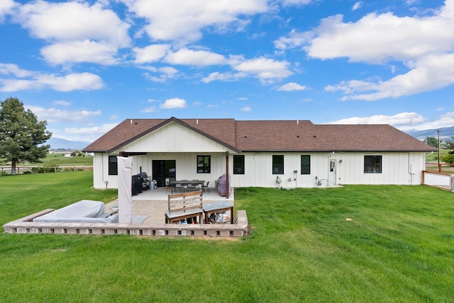 219 Rudys Way, Hamilton, MT 59840 - back of property with a yard, a patio area, roof with shingles, and board and batten siding