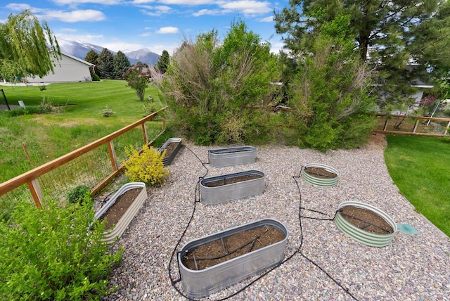 219 Rudys Way, Hamilton, MT 59840 - view of green lawn featuring a mountain view and a vegetable garden