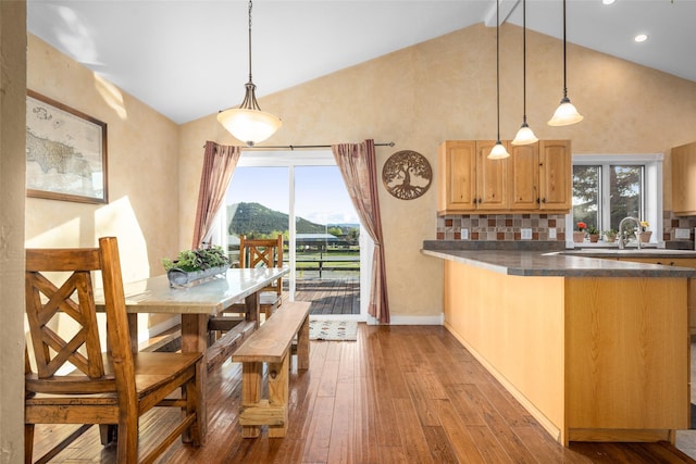 280 Hartt Hill Dr, Kalispell, MT 59901 - dining space with wood-type flooring, high vaulted ceiling, a mountain view, recessed lighting, and baseboards