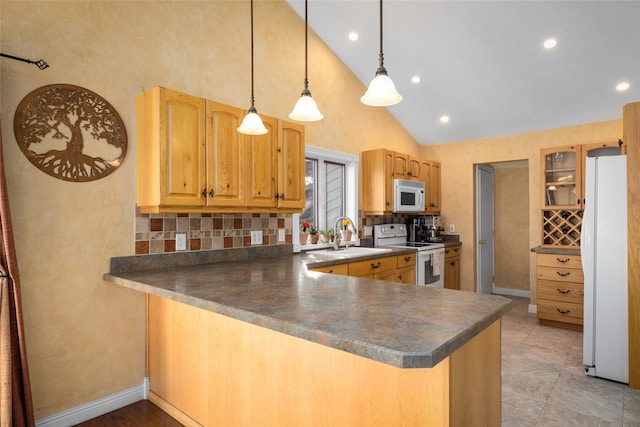 280 Hartt Hill Dr, Kalispell, MT 59901 - kitchen with white appliances, a sink, dark countertops, high vaulted ceiling, and decorative backsplash