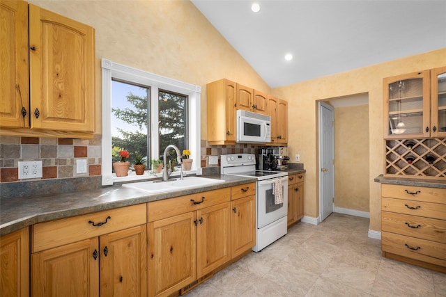 280 Hartt Hill Dr, Kalispell, MT 59901 - kitchen with white appliances, a sink, decorative backsplash, dark countertops, and glass insert cabinets