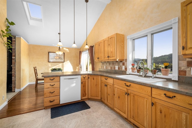 280 Hartt Hill Dr, Kalispell, MT 59901 - kitchen featuring dishwasher, a sink, dark countertops, a peninsula, and a skylight