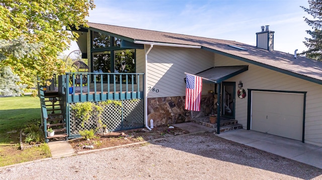 280 Hartt Hill Dr, Kalispell, MT 59901 - view of home's exterior featuring driveway, a garage, roof with shingles, a chimney, and stairs