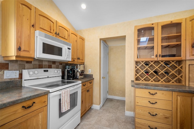 280 Hartt Hill Dr, Kalispell, MT 59901 - kitchen with white appliances, dark countertops, glass insert cabinets, vaulted ceiling, and decorative backsplash