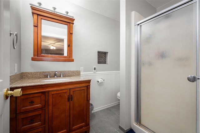 280 Hartt Hill Dr, Kalispell, MT 59901 - bathroom with toilet, wainscoting, a shower stall, vanity, and tile patterned flooring