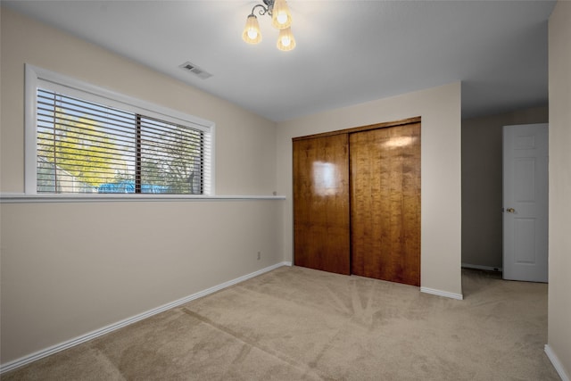 280 Hartt Hill Dr, Kalispell, MT 59901 - unfurnished bedroom featuring carpet flooring, baseboards, a closet, and a chandelier