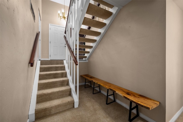 280 Hartt Hill Dr, Kalispell, MT 59901 - stairs featuring carpet floors, baseboards, and a chandelier