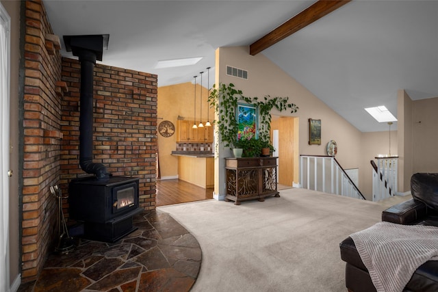 280 Hartt Hill Dr, Kalispell, MT 59901 - living area with a wood stove, a skylight, and stone finish floors