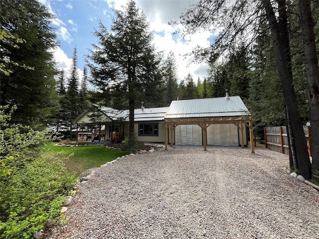 14367 US Highway 2 E, Essex, MT 59916 - view of front of house with gravel driveway, metal roof, and an attached garage