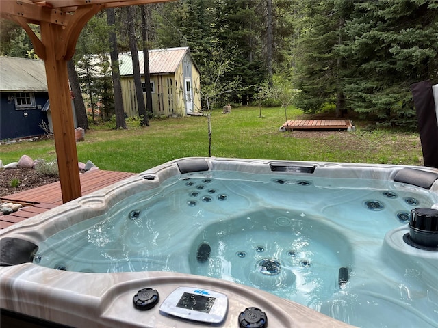 14367 US Highway 2 E, Essex, MT 59916 - exterior space with a deck, an outbuilding, and a hot tub