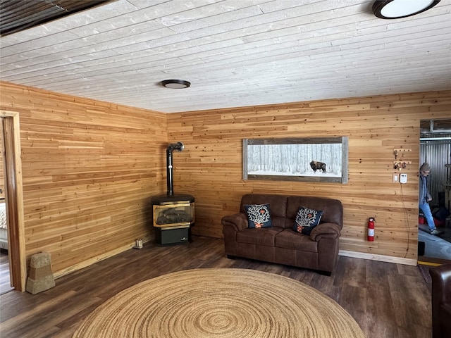 14367 US Highway 2 E, Essex, MT 59916 - living area with wooden walls, wood finished floors, baseboards, a wood stove, and wood ceiling