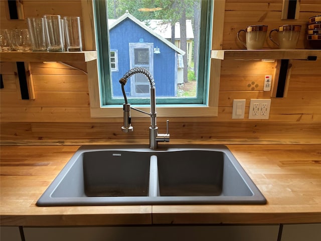 14367 US Highway 2 E, Essex, MT 59916 - kitchen view of a sink, wooden walls, and butcher block counters