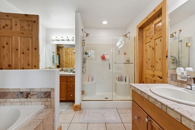 14132 Pine St, Bigfork, MT 59911 - bathroom featuring a stall shower, two vanities, tile patterned floors, and a garden tub