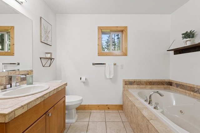 14132 Pine St, Bigfork, MT 59911 - full bathroom featuring a tub with jets, baseboards, toilet, vanity, and tile patterned floors