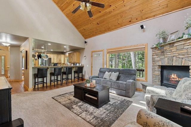 14132 Pine St, Bigfork, MT 59911 - living room with a ceiling fan, light carpet, high vaulted ceiling, baseboards, and wooden ceiling