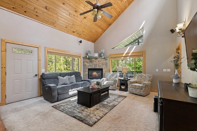 14132 Pine St, Bigfork, MT 59911 - carpeted living area featuring high vaulted ceiling, wooden ceiling, a fireplace, ceiling fan, and baseboards