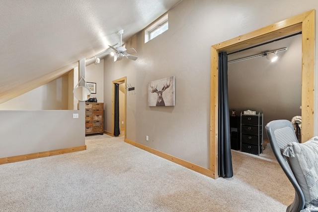 14132 Pine St, Bigfork, MT 59911 - additional living space with carpet, lofted ceiling, baseboards, and a ceiling fan