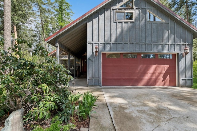 14132 Pine St, Bigfork, MT 59911 - view of front of property featuring board and batten siding and concrete driveway