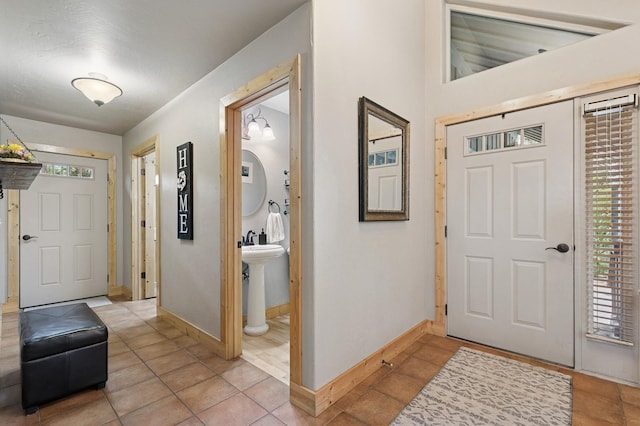 14132 Pine St, Bigfork, MT 59911 - entryway with healthy amount of natural light, baseboards, and light tile patterned floors