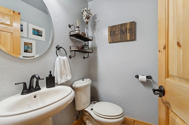 14132 Pine St, Bigfork, MT 59911 - half bathroom with a sink and toilet