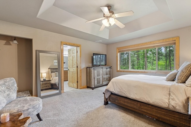 14132 Pine St, Bigfork, MT 59911 - bedroom featuring a raised ceiling, light colored carpet, a ceiling fan, and ensuite bathroom