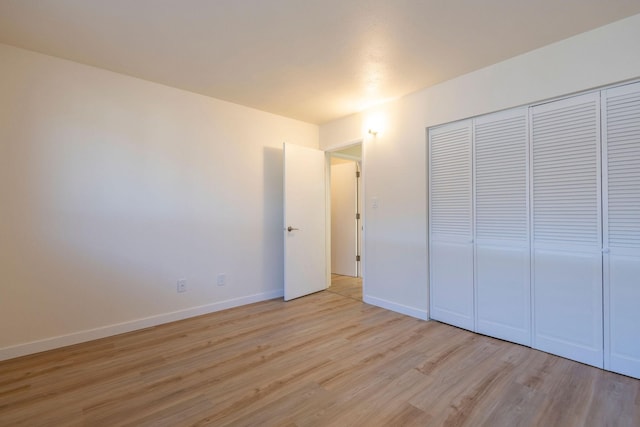1624 Cannon St Unit 26, Helena, MT 59601 - unfurnished bedroom featuring light wood-style flooring, baseboards, and a closet