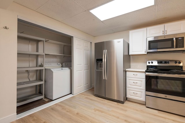 1624 Cannon St Unit 26, Helena, MT 59601 - kitchen with appliances with stainless steel finishes, white cabinetry, light wood-type flooring, light countertops, and a paneled ceiling